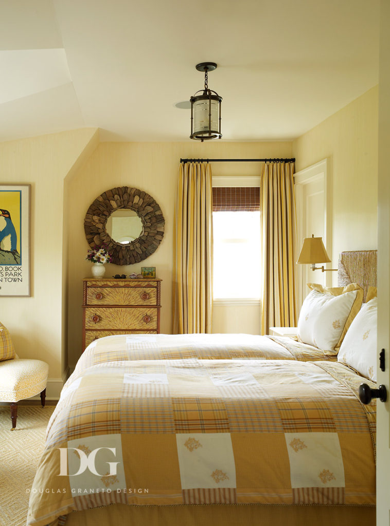 Relaxing guest bedroom featuring a circular mirror and other furnishings from Pierre Frey and Chelsea Editions.