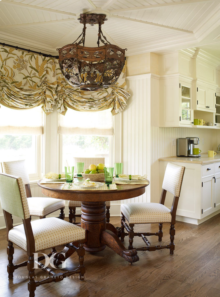 Breakfast nook featuring a rustic chandelier and other Carlos de la Puente antiques.