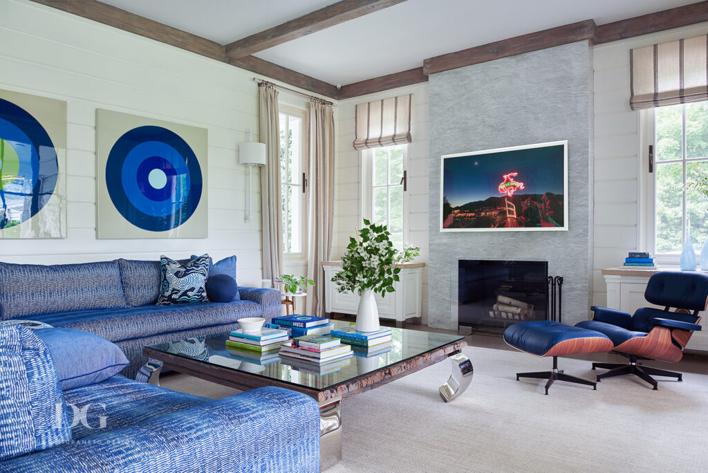 Living room with blue sectional and blue leather Eames lounger