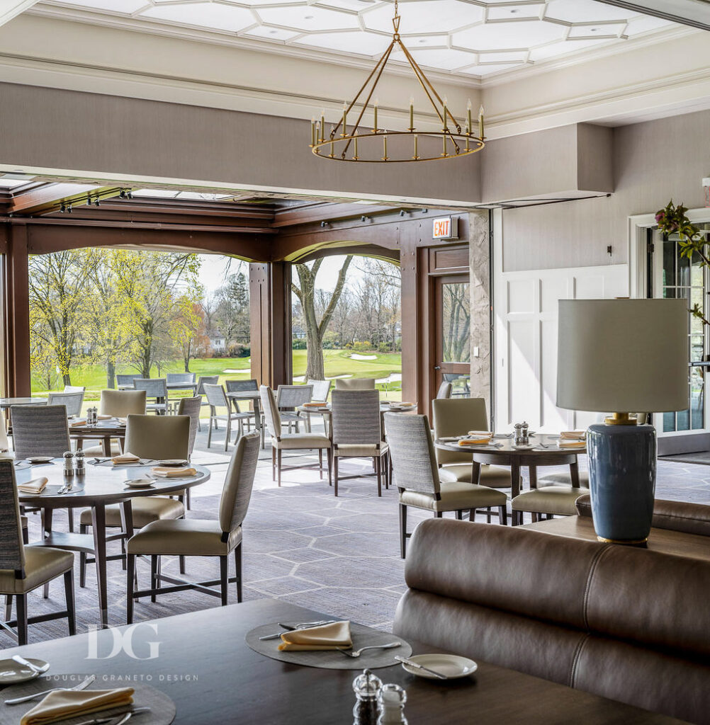 Country club dining room with modern decor, looking out at golf course