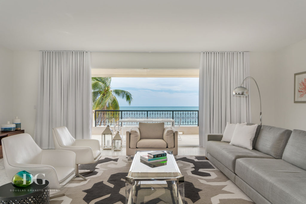 wide window opening onto balcony overlooking the beach