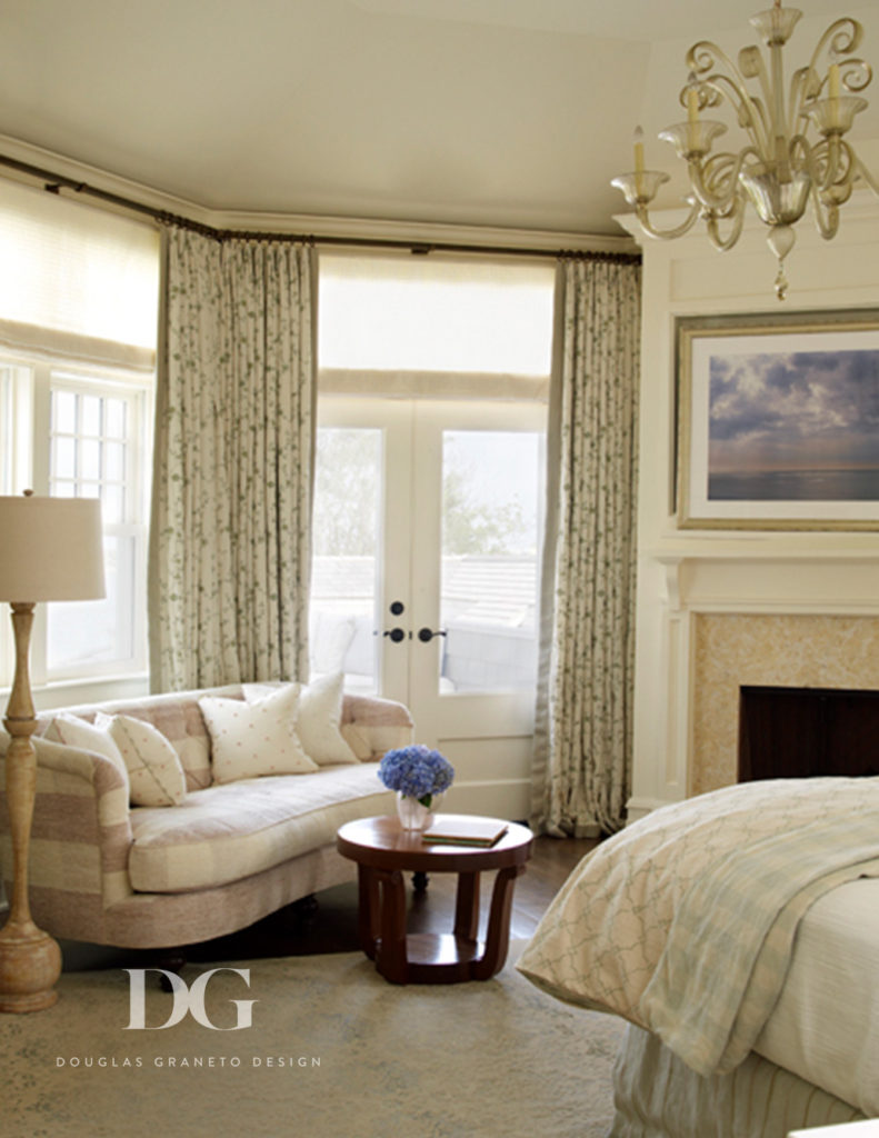 Classic Southampton master bedroom featuring a chandelier, fireplace, and textiles from Chelsea Editions.