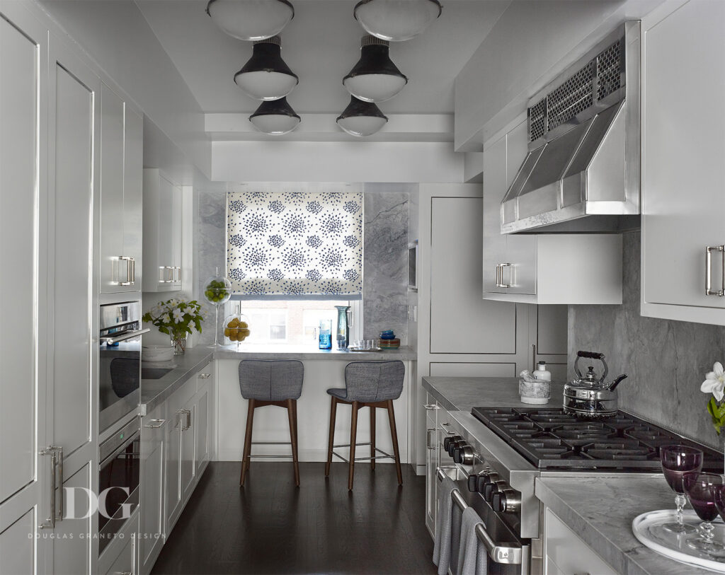 White apartment kitchen with Lepere counter stools and Urban Electric light fixtures