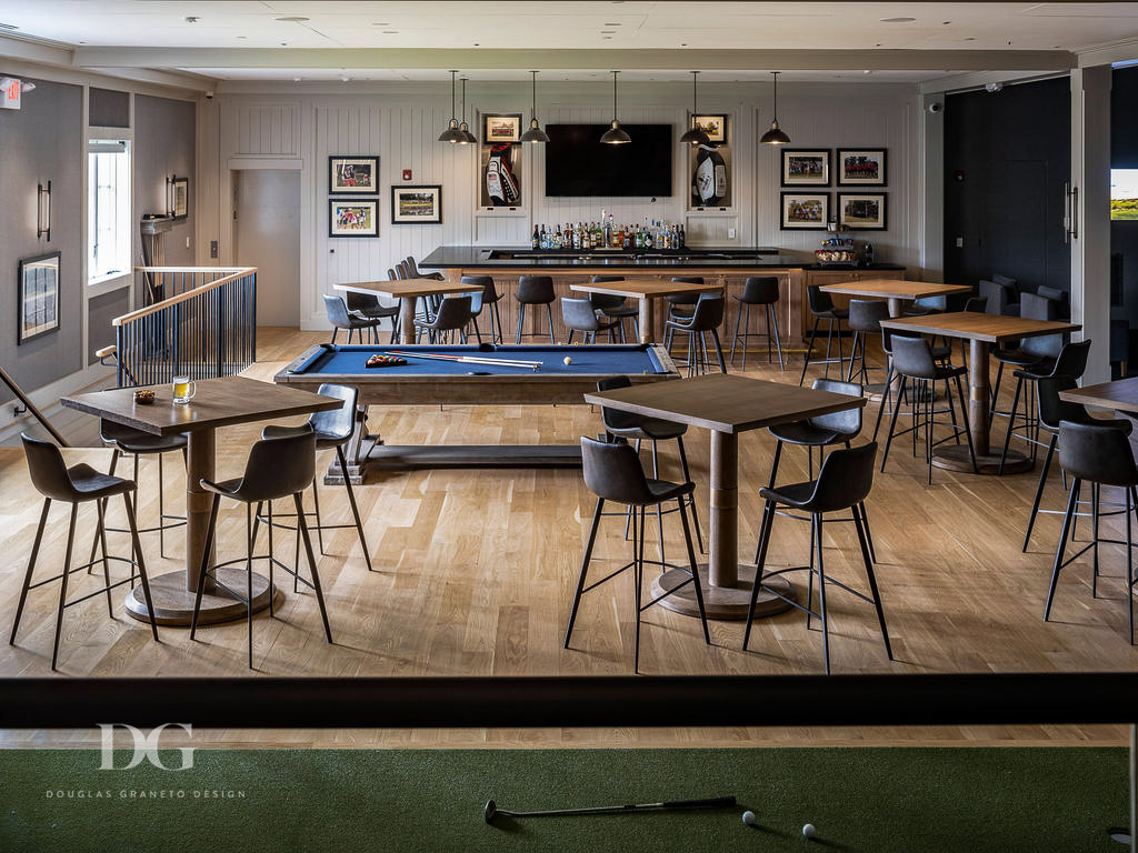 Country club pro shop bar view of whole room with high top tables, Philip Jeffries wallpaper and brown leather Arhaus stools