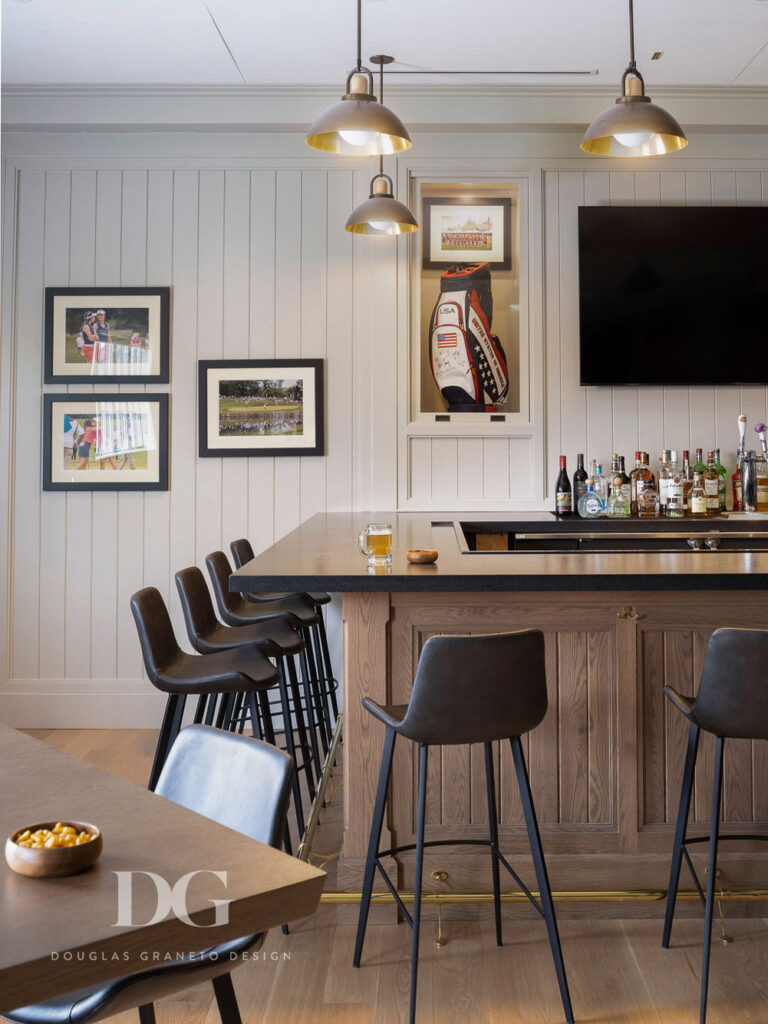 Corner of country club pro shop bar with brown leather stools and Allied Maker pendants
