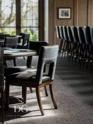 Leather dining chair with Cowton & Tout tweed fabric back, in pub with Crossley Axminster rug